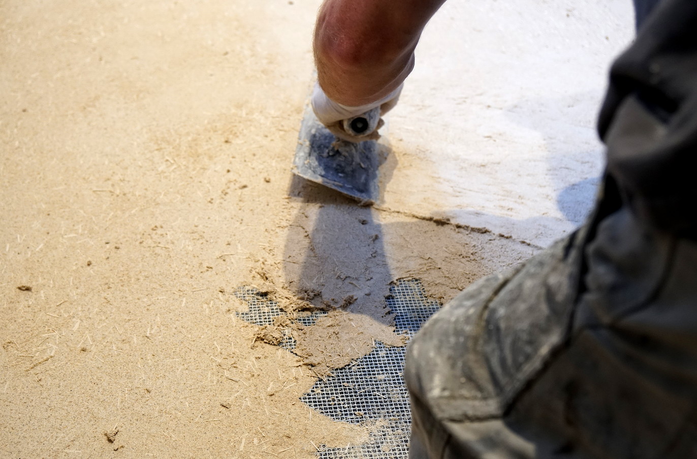 Hand troweled concrete scratch coat on floor